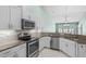 Stylish kitchen with stainless steel appliances, granite countertops, white cabinets, and a mosaic backsplash at 156 Parmelee Dr. # D, Murrells Inlet, SC 29576