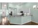 Open kitchen with bar seating, stainless steel appliances, granite countertops, and white cabinets at 156 Parmelee Dr. # D, Murrells Inlet, SC 29576