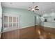 Spacious living room featuring hardwood floors, a ceiling fan and an open concept kitchen at 156 Parmelee Dr. # D, Murrells Inlet, SC 29576