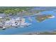 Aerial view of a marina with multiple boats docked in the blue water at 156 Parmelee Dr. # D, Murrells Inlet, SC 29576