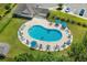 Aerial view of a refreshing community pool with lounge chairs, umbrellas, and lush landscaping at 156 Parmelee Dr. # D, Murrells Inlet, SC 29576