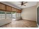 Cozy sunroom with wood floors, window coverings, and a ceiling fan, providing a relaxing indoor-outdoor space at 156 Parmelee Dr. # D, Murrells Inlet, SC 29576