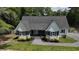 Stunning aerial view of a picturesque home with black shutters and a green lawn at 160 Comanche Dr., Georgetown, SC 29440