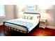 Cozy bedroom featuring wood floors, neutral walls, modern lighting, and a comfortable queen-size bed at 160 Comanche Dr., Georgetown, SC 29440