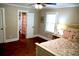 Bright bedroom with hardwood floors, a ceiling fan and an ensuite bathroom at 160 Comanche Dr., Georgetown, SC 29440