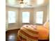 Bright bedroom with hardwood floors, bay windows, a ceiling fan and a colorful bedspread at 160 Comanche Dr., Georgetown, SC 29440