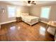 Bedroom with hardwood floors, a ceiling fan and a bed with a floral bedspread at 160 Comanche Dr., Georgetown, SC 29440