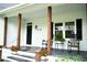 Charming front porch with rocking chairs and potted flowers, creating a welcoming entrance at 160 Comanche Dr., Georgetown, SC 29440