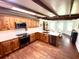 Well-lit kitchen features wood beams, wood cabinets, white countertops and stainless steel appliances at 160 Comanche Dr., Georgetown, SC 29440