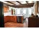 Well-lit kitchen with wood beams, wooden cabinets, white countertops and stainless appliances at 160 Comanche Dr., Georgetown, SC 29440