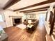 Cozy living room features a brick fireplace, exposed wood beams, and hardwood floors at 160 Comanche Dr., Georgetown, SC 29440