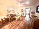 Inviting living room with leather sofa, neutral decor, wood floors, and view into the office at 160 Comanche Dr., Georgetown, SC 29440