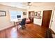 Home office featuring hardwood floors, natural light, built-in shelving, desk, and comfortable seating at 160 Comanche Dr., Georgetown, SC 29440