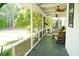 Relaxing screened-in porch with ceiling fans and comfortable seating, perfect for enjoying the outdoors at 160 Comanche Dr., Georgetown, SC 29440