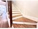 Staircase featuring wood steps, white risers, a dark wood handrail, and wood floors at 160 Comanche Dr., Georgetown, SC 29440
