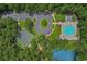 Aerial view showcasing the community pool, tennis courts, and surrounding trees at 161 Barclay Dr., Myrtle Beach, SC 29579