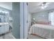 Bedroom view, showing a ceiling fan, stylish furniture, and en suite bathroom at 161 Barclay Dr., Myrtle Beach, SC 29579