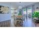 Bright dining area with a chandelier, patio access, and an open view into the adjacent kitchen at 161 Barclay Dr., Myrtle Beach, SC 29579