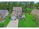 Well-maintained two-story home with attached garage, beautiful landscaping, and lush green lawn in a desirable neighborhood at 161 Barclay Dr., Myrtle Beach, SC 29579