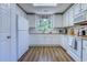 Bright kitchen features white cabinets, modern appliances, and a charming window with a view at 161 Barclay Dr., Myrtle Beach, SC 29579