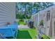 Outdoor patio featuring a dining table, artificial turf, and grill for entertainment at 161 Barclay Dr., Myrtle Beach, SC 29579