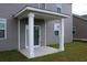Covered back patio with white support beams, gray siding, and view of the well-maintained lawn at 161 Londonshire Dr., Myrtle Beach, SC 29579