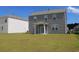 Home's backyard with a gray siding, a covered patio, and a lush green lawn at 161 Londonshire Dr., Myrtle Beach, SC 29579