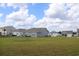 View of multiple backyards, each with gray siding, a lush green lawn, and well-maintained landscaping at 161 Londonshire Dr., Myrtle Beach, SC 29579