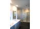 Modern bathroom with double sink vanity, shower, glass doors, and hard wood floors at 161 Londonshire Dr., Myrtle Beach, SC 29579