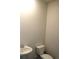 A powder room featuring a pedestal sink and toilet, offering convenience and simplicity at 161 Londonshire Dr., Myrtle Beach, SC 29579
