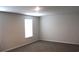 An empty bedroom with carpet, white walls, base trim, and a window at 161 Londonshire Dr., Myrtle Beach, SC 29579