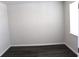 An empty bedroom with dark floors, white walls, base trim, and a window at 161 Londonshire Dr., Myrtle Beach, SC 29579