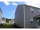 Side view of a home featuring gray siding and a well-maintained lawn in a residential neighborhood at 161 Londonshire Dr., Myrtle Beach, SC 29579