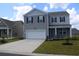 Two-story home with gray siding, black shutters, a two-car garage, and a manicured front lawn at 161 Londonshire Dr., Myrtle Beach, SC 29579