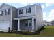 Charming two-story home with gray siding, black shutters, and a covered front porch at 161 Londonshire Dr., Myrtle Beach, SC 29579