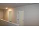 Hallway with carpeted floors, white walls, base trim, and several white doors at 161 Londonshire Dr., Myrtle Beach, SC 29579