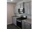 Close up of a kitchen with a gas range, stainless steel microwave, and light gray cabinets at 161 Londonshire Dr., Myrtle Beach, SC 29579