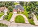Aerial shot showcasing a well-maintained home with a circular driveway and lush landscaping at 1619 Deer Park Ln., Surfside Beach, SC 29575