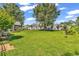 A fenced backyard showcasing a well-maintained lawn, garden beds, and ample space for recreation at 1619 Deer Park Ln., Surfside Beach, SC 29575