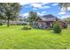 Spacious backyard showcasing a covered patio, lush lawn, and landscaping at 1619 Deer Park Ln., Surfside Beach, SC 29575
