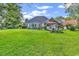 A beautiful backyard featuring a lush lawn, patio, and sunroom, ideal for outdoor relaxation and entertaining at 1619 Deer Park Ln., Surfside Beach, SC 29575