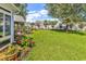 Landscaped backyard with a covered patio, perfect for enjoying outdoor dining and relaxation at 1619 Deer Park Ln., Surfside Beach, SC 29575