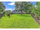 Expansive backyard with a large shade tree and manicured lawn, providing plenty of space and privacy at 1619 Deer Park Ln., Surfside Beach, SC 29575