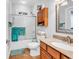 Bathroom featuring tile flooring, wood vanity, shower, storage, and ample natural light at 1619 Deer Park Ln., Surfside Beach, SC 29575