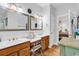 Bathroom with double sinks, tile floors, and an adjoining doorway to the bedroom at 1619 Deer Park Ln., Surfside Beach, SC 29575