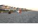A scenic view of the beach with colorful beachfront houses in the background, ideal for coastal living at 1619 Deer Park Ln., Surfside Beach, SC 29575