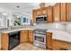 Kitchen featuring oak cabinets, a stainless steel oven, and a breakfast bar that opens to a living space at 1619 Deer Park Ln., Surfside Beach, SC 29575