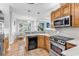 Spacious kitchen featuring oak cabinets, stainless steel appliances, and tile floors with a breakfast nook at 1619 Deer Park Ln., Surfside Beach, SC 29575