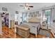 Bright main bedroom with hardwood floors, a ceiling fan, and a walk-in closet at 1619 Deer Park Ln., Surfside Beach, SC 29575