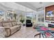 Bright sunroom with tile floors, floor-to-ceiling windows, comfortable seating, and access to the backyard at 1619 Deer Park Ln., Surfside Beach, SC 29575